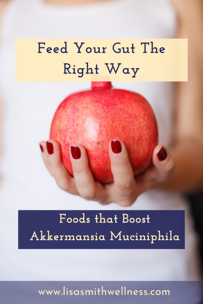woman with red nails holding a whole pomegranate. overlay text reads "foods that boost akkermansia muciniphila"